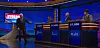 Alex Trebek points at Kevin Bohannon's podium on the April 15, 2019 episode of Jeopardy!, signalling that he has control of the board. Note the white light at the bottom left of the podium.